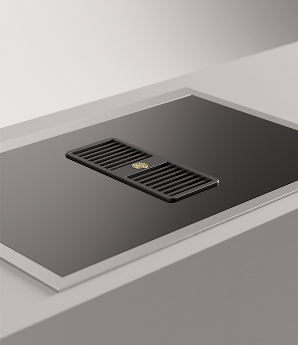 Sleek, black kitchen cooktop with induction and integrated hood